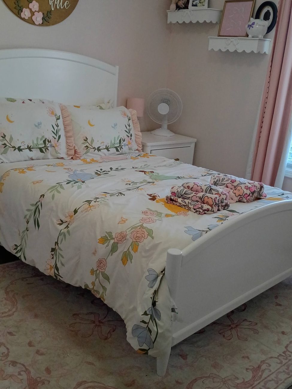 A tidy bedroom with the bed made and surfaces cleared